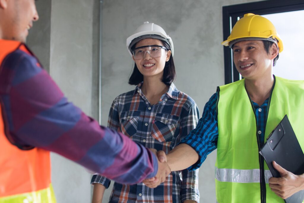 Handshake with 2 other construction workers after setting up growth strategy framework